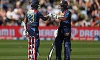 Sri Lanka's Kusal Mendis (L) celebrates 50 runs with teammate Kusal Perera during the third Twenty20 cricket match between New Zealand and Sri Lanka