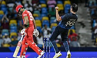 Oman's Naseem Khushi (L) is bowled by Namibia's David Wiese