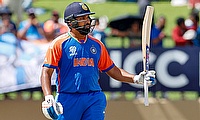 India's captain Rohit Sharma celebrates his half-century
