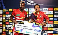 Man of the Match Andre Russell of Trinbago Knight Riders collects his awards from Venky Mysore