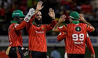 Moeen Ali (2L) and Shai Hope (L) of Guyana Amazon Warriors celebrate