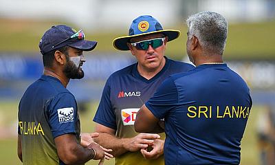 Sri Lanka's captain Dimuth Karunaratne (L) chats with coach Chris Silverwood (C)