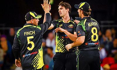 Pat Cummins celebrates a wicket with team mates