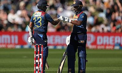 Sri Lanka's Kusal Mendis (L) celebrates 50 runs with teammate Kusal Perera during the third Twenty20 cricket match between New Zealand and Sri Lanka