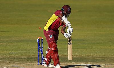 West Indies' Kyle Mayers is bowled