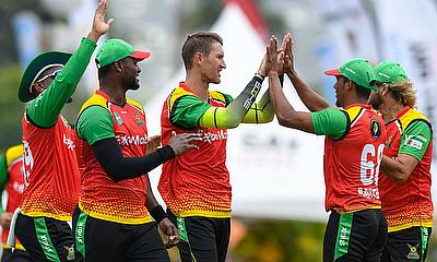 Dwaine Pretorius (C), Romario Shepherd (2L) and Gudakesh Motie (2R) of Guyana Amazon Warriors celebrate