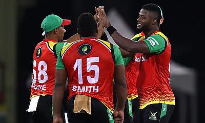 Romario Shepherd of Guyana Amazon Warriors celebrates with teammates after getting the wicket of Kieron Pollard