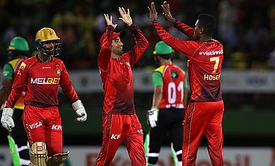 Akeal Hosein of Trinbago Knight Riders celebrates with teammates