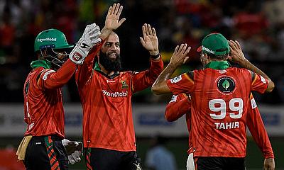 Moeen Ali (2L) and Shai Hope (L) of Guyana Amazon Warriors celebrate