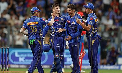 Mumbai Indians' Mitchell Santner celebrates with teammates after taking the caught and bowled wicket of Delhi Capitals' Vipraj Nigam Mumbai Indians' Mitchell Santner celebrates with teammates after taking the caught and bowled wicket of Delhi Capitals' Vipraj Nigam