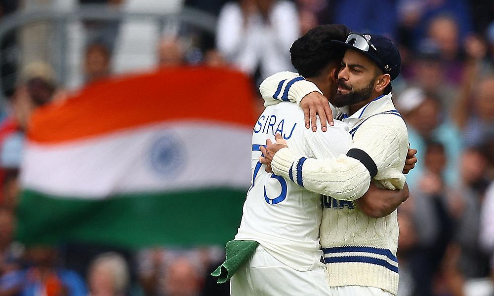 India's Mohammed Siraj celebrates after taking the wicket of Australia's Usman Khawaja with Virat Kohli