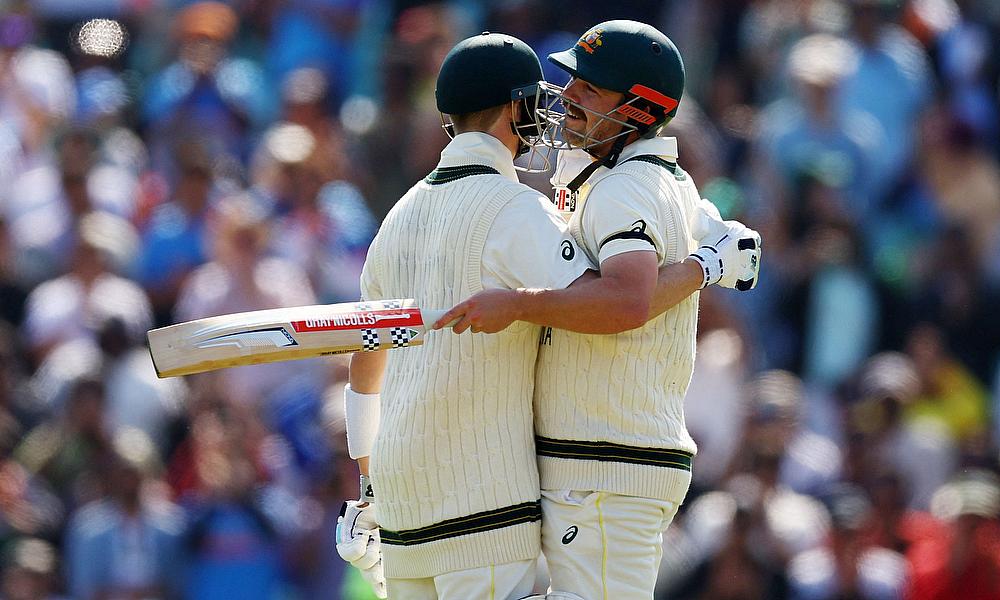 Australia's Travis Head celebrates reaching his century with Steven Smith