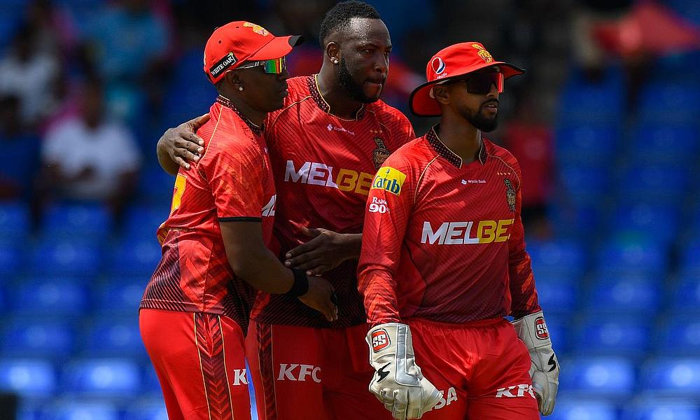 Dwayne Bravo (L), Andre Russell (C) and Nicholas Pooran (R) of Trinbago Knight Riders celebrates the dismissal of Faf Du Plessis