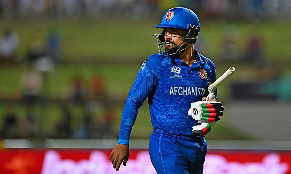 Afghanistan's captain Rashid Khan walks off