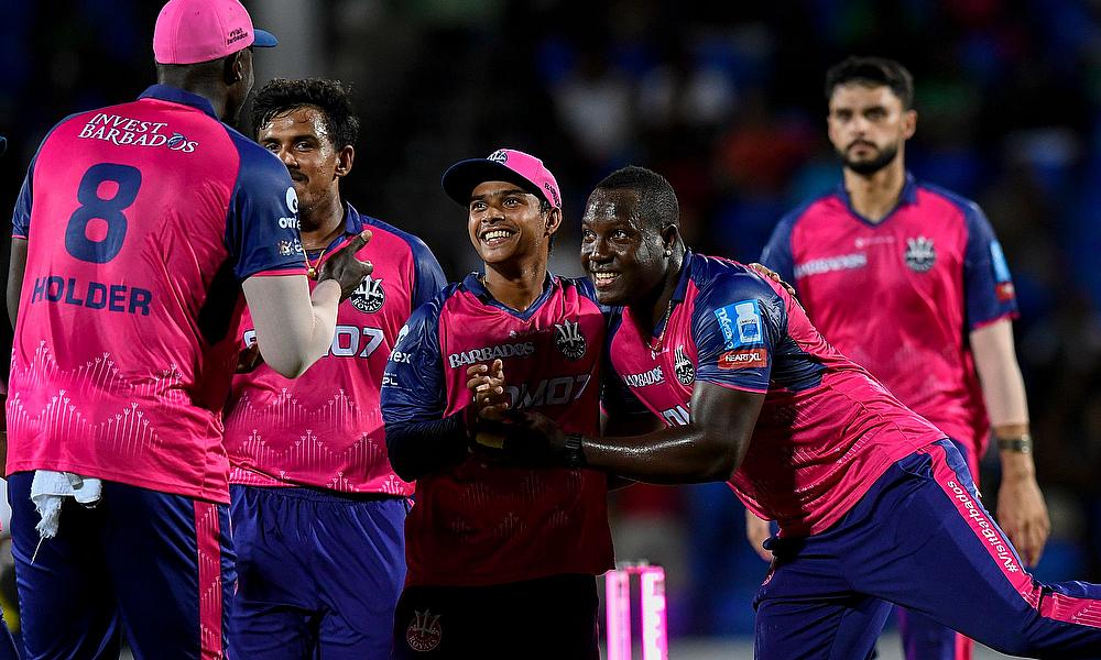 Dinuth Wellalage (2R) and Rovman Powell (R) of Barbados Royals celebrate