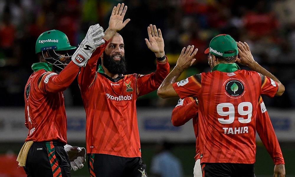 Moeen Ali (2L) and Shai Hope (L) of Guyana Amazon Warriors celebrate